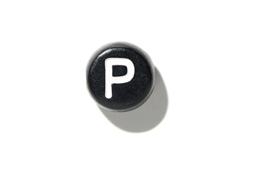 Black button with white letter p isolated on white background with shadow creating bold contrast...