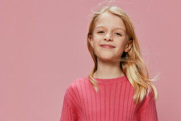 Happy Schoolgirl with Stylish Pink Outfit Smiling in Studio, Expressing Joy and Excitement She is a...