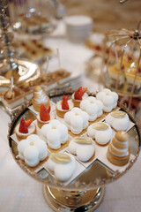 Sweet cakes with filling on a stand on the buffet table.