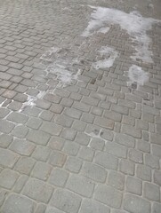 paving texture. The paving stones are covered with ice. Sidewalk in the cold season