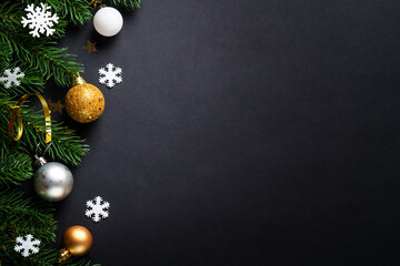 Black christmas background with holiday decorations, elegant modern style. Flat lay with space for text.