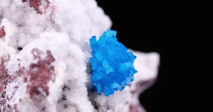 Cavansite crystals on stilbite rotating footage. isolated on black background. Specimen from Wagholi, India. macro detail close-up mineral crystal unpolished semi-precious gemstone.