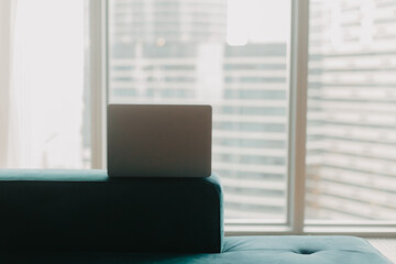 Laptop against the background of a skyscraper window.