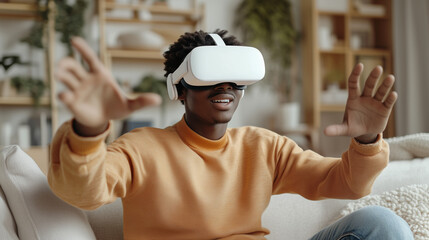 Young Man Using VR Headset at Home with Hands Raised