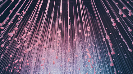 Artistic installation featuring hanging strands with suspended pink and white elements in a contemporary exhibition space