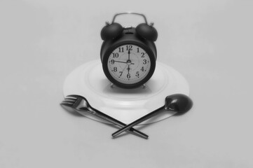 clock on an inverted plate black and white background
