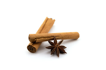 Cinnamon sticks and anise isolated on white background. Cinnamon roll and star anise. Spicy spice for baking, desserts and drinks. Fragrant ground cinnamon. Perfect for Christmas season.