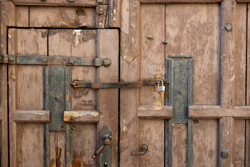 Closed Old vintage wood Door with door lock. Lock with a latch on an old brown door