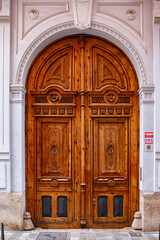 Wooden Entrance Doors With Ornate Carvings in an Urban Setting During the Daytime