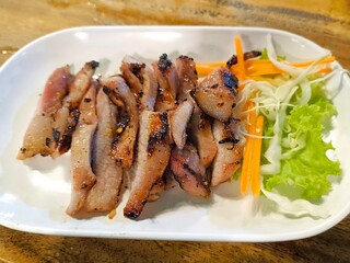 Thai style grilled pork neck. Kor Moo Yang. Thai street food menu