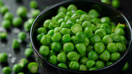 Fresh green peas nestled in a black bowl