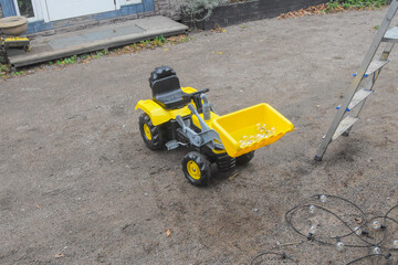 a child boy on a wheeled bulldozer tractor electrical work bulbs and light, photo without filters