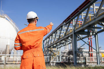 Back view of petroleum engineer work at oil refinery site