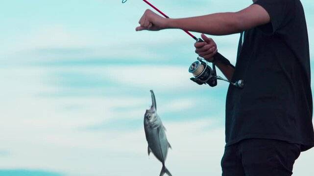 A man managed to catch a trevally using a fishing rod