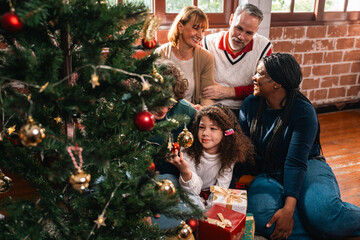 Celebrate Joyful Christmas Eve at Home, Happy Family Including a Smiling Father, Mother, and Children, Gather Together Around the Festively Decorated Tree, Sharing Love Excitement for New Year Gifts