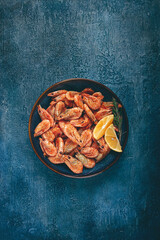 fried shrimp, with shell and head, unpeeled, size 70-90, on a blue background, homemade, no people,