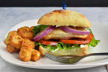 chicken sandwich  with a side of tater tots