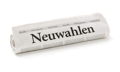 Zeitungsrolle mit der Überschrift Neuwahlen