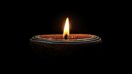 Close-up image of a Happy Diwali diya against a black background