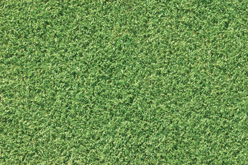 Artificial grass fake turf synthetic lawn field macro closeup, bright green sports astroturf texture, natural horizontal textured background pattern, large detailed copy space