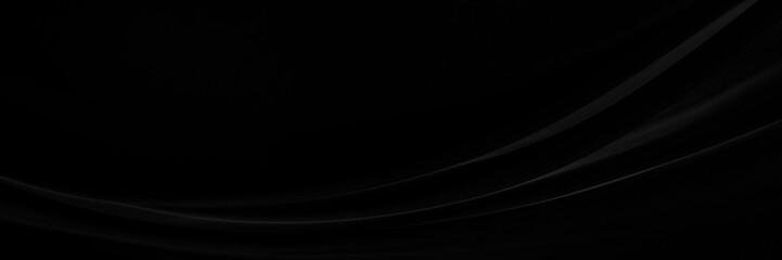 Black gray satin dark fabric texture luxurious shiny that is abstract silk cloth panorama background with patterns soft waves blur beautiful.