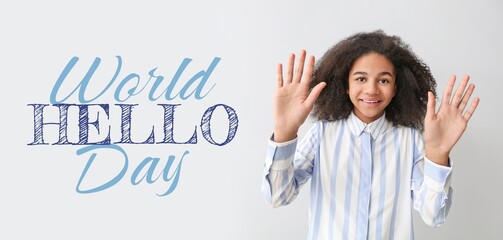 Banner for World Hello Day with African-American teenage girl waving hands on light background