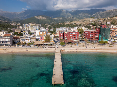Aerial drone photo of boulevard and beach in the coastal town of Himare in Albania.