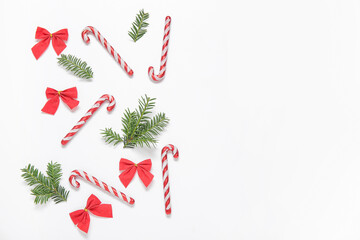 Candy canes and Christmas decorations on white background