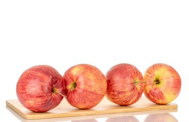 Several red apples on a wooden kitchen board, macro, isolated on white background.