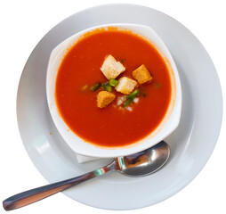 Traditional cold soup gazpacho served with vegetables, squabs, peppers and baked breads in plate. Spanish cuisine. Isolated over white background