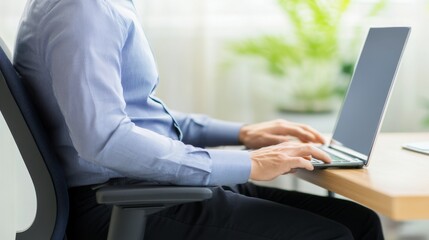 Person sitting at desk with poor posture, emphasizing the importance of ergonomic practices for maintaining health and productivity in the workplace.