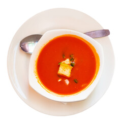 Tomato gazpacho soup with chicken peppers and onions served in bowl with croutons. Isolated over white background