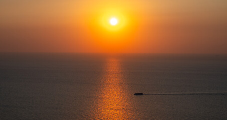 Blue ocean sea water wave reflections at the sunset. Motor boat in the blue ocean.