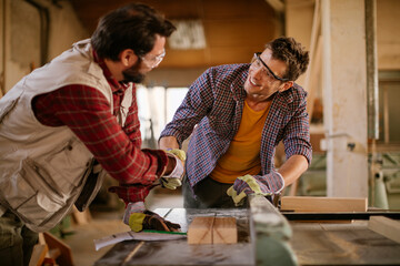 Carpenters having a handshake in the woodworking workshop