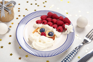 Plate with pancake in shape of Santa on white background. Christmas celebration
