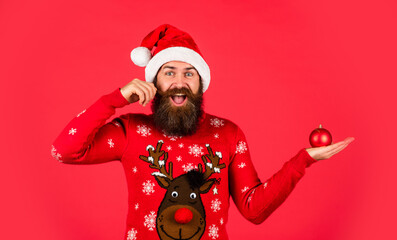 Waiting for wonder. surprise for xmas holiday. gifts and presents preparation. new year party. mature and brutal hipster in santa hat. happy bearded man in sweater. its christmas time. copy space