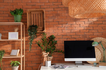 Workplace with computer and green plants in office