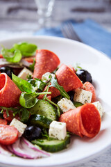 Salad with Salami, Feta Cheese, Black Olives, Cucumber and Cherry Tomatoes. Close up