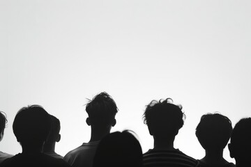 Image of multiple people's silhouettes from behind set against a stark white background