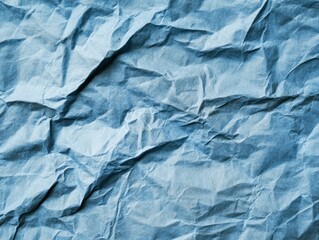 Fototapeta premium A close-up of crumpled blue paper texture, showcasing its intricate folds and shadows.
