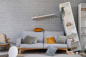 Interior of messy living room with overturned furniture after earthquake
