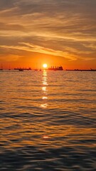 Stunning sunset. Ships on the horizon in the rays of the setting sun