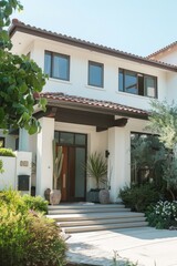 Fototapeta premium A white house with a red roof and a brown door, suitable for use in real estate or architecture illustrations