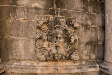 Water faucet in medieval town with a ornament