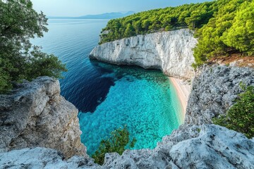 Fototapeta premium A large body of water meets the rugged coastline and steep cliff face, great for travel or nature photography