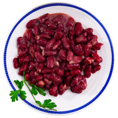 Plate contains light side dish of stewed vegetables - red kidney beans. Diet menus, vegetable appetizer. Isolated over white background