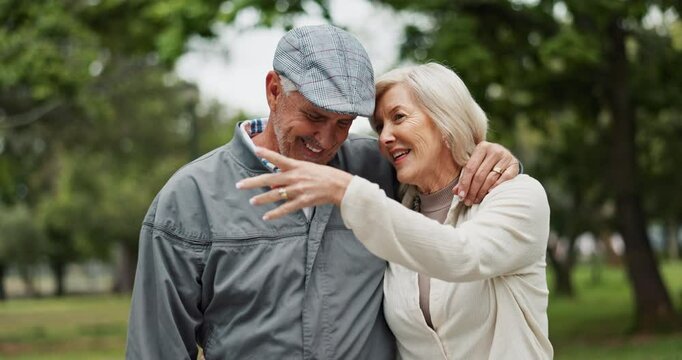 Senior, happy couple and walking with hug in nature for bonding, retirement or enjoying stroll at outdoor park. Mature, man or woman with smile in forest for sightseeing adventure or journey together