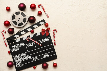 Composition with film reel, movie clapper and Christmas decorations on white background. Top view