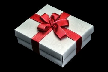 Obraz premium A white gift box wrapped with a red ribbon, perfect for presenting presents and gifts