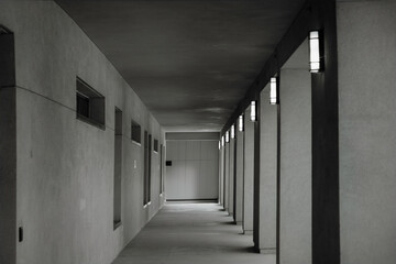 Long grey empty exterior hallway in building overhang, concrete, nobody